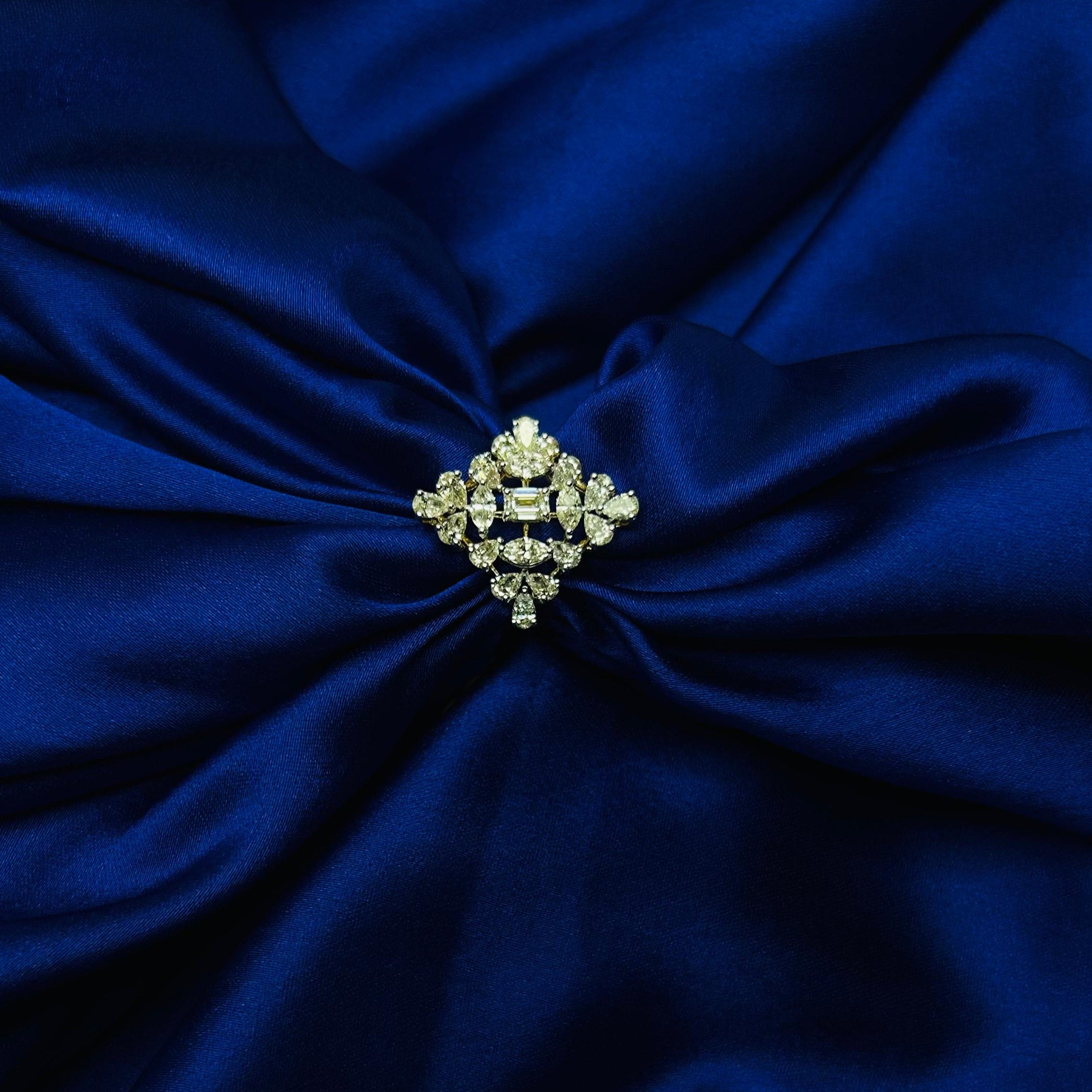 Decorative brooch on a blue fabric background