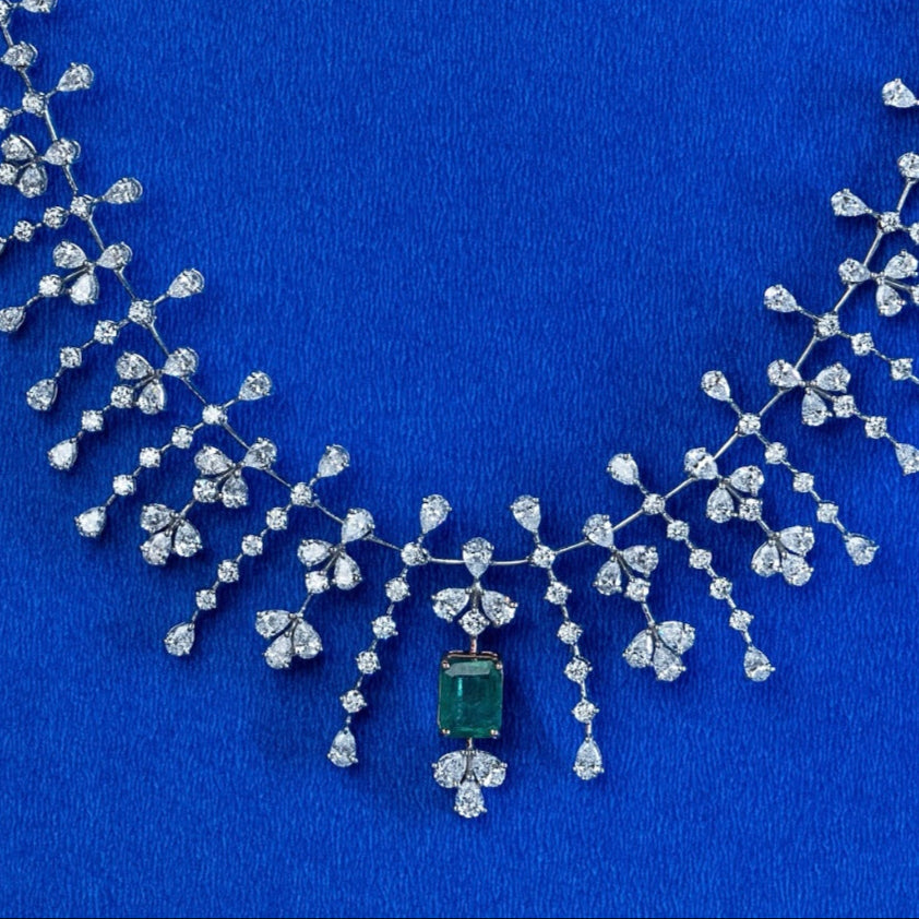 Jewelry set with necklace and earrings on a blue background